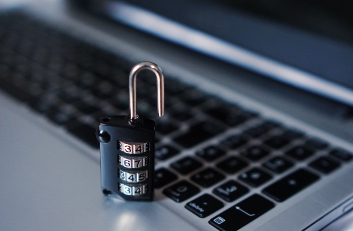 unlock black and grey numerical combination padlock placed on laptop 2k 4k 5k