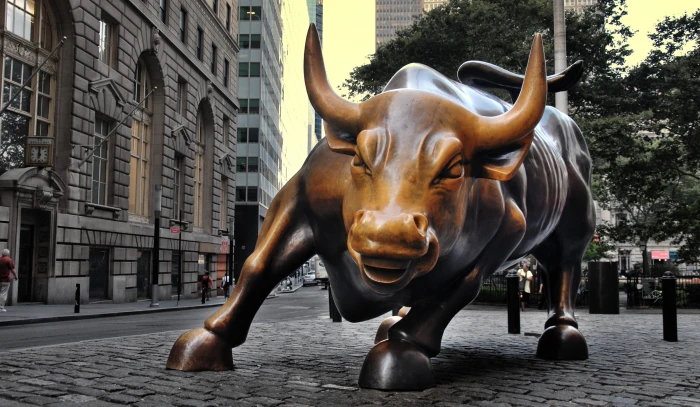 brown bull concrete statue under high rise building background 2k