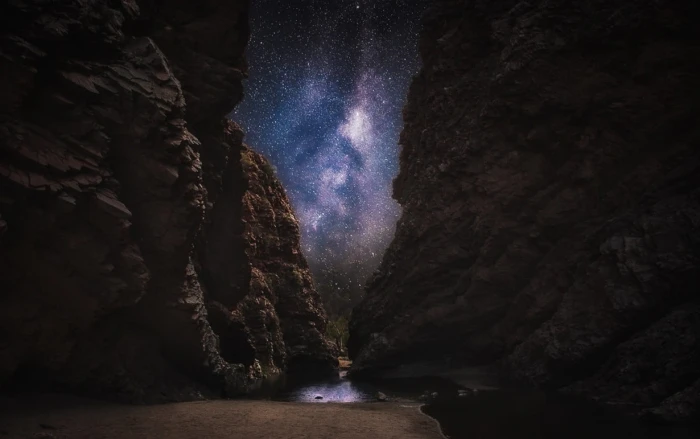 calm body of water in between rock formation nature landscape