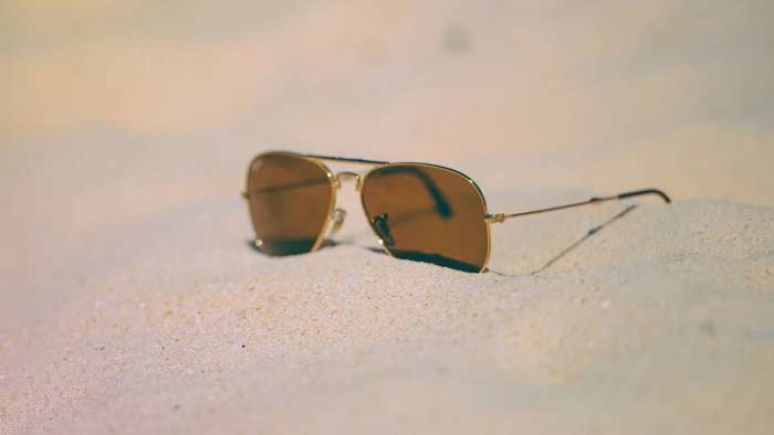 brown Ray Ban Aviator sunglasses with silver frames sand beach 2k
