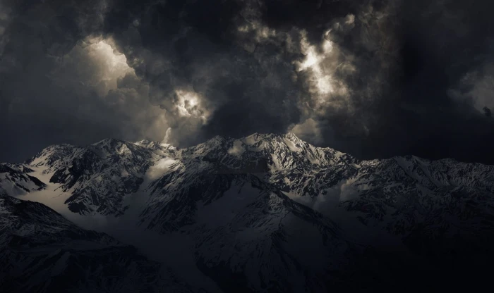 landscape nature mountains storm dark snowy peak sunlight summit clouds