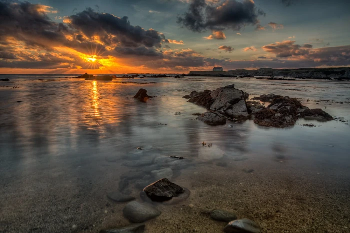 sea shore and body of water during sunset St Cwyfan Island