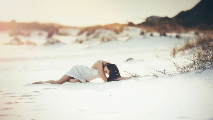 woman in white dress on sandy area under gray sky women beach 2k