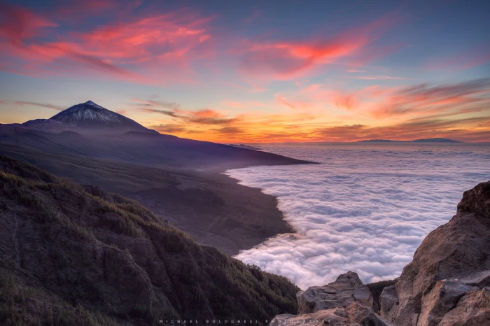 aerial photography of mountain during sunset Holding up Sky 2k