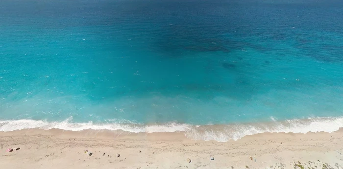 aerial view of seashore during day time beach land water sand 2k