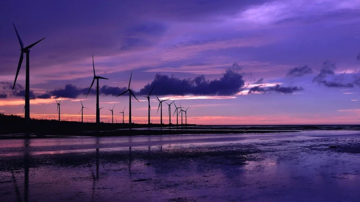 wind mills near body of water purple sky landscape turbine 2k