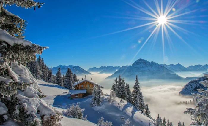 winter sun rays cottage snow mountains forest snowy peak 2k