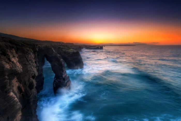 time lapse photography of rocky mountain with splash sea landscape