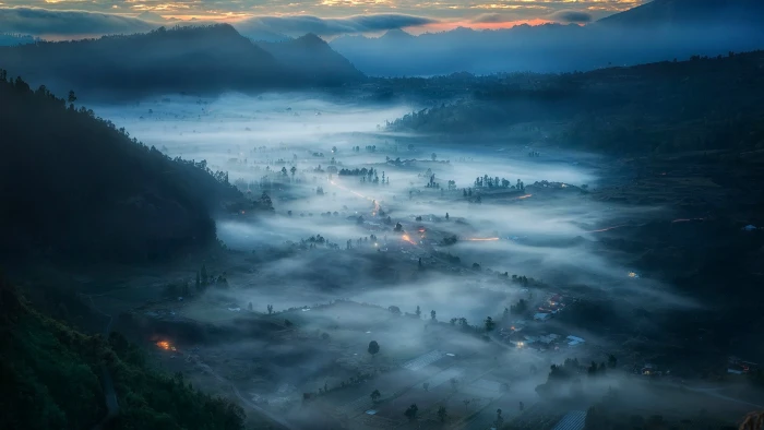 green grass covered mountain aerial photo of valley at night time 2k