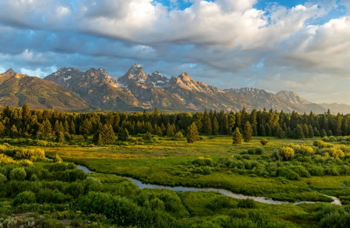landscape photography of green fields mountains and cumulus clouds during daytime