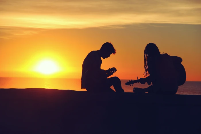 silhouette of man and woman playing guitars guitar during sunset 2k 4k 5k