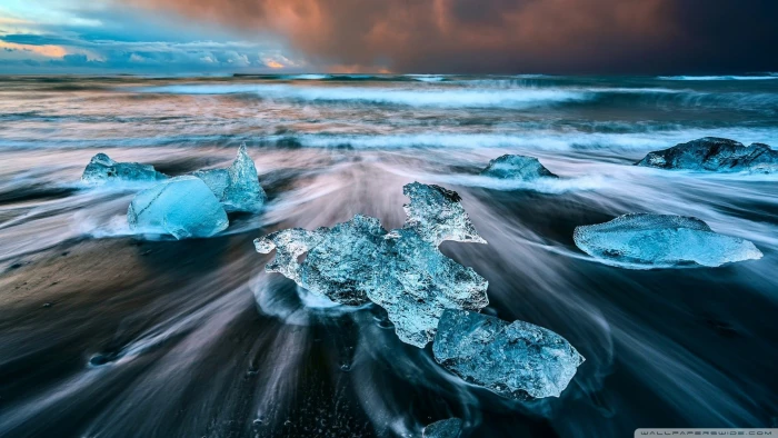 teal rock on body of water wallpaper ice beach Iceland sea 2k