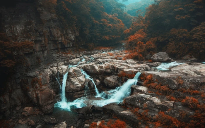 waterfalls surrounded by rocks landscape photo of 2k