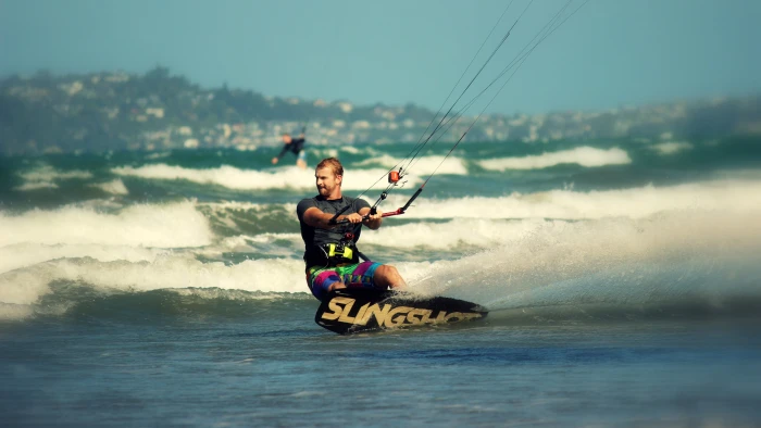 black and brown Slingshot wakeboard men surfing beach waves 2k
