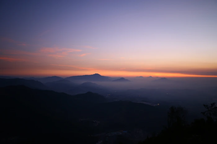 fog covering mountains misty with sun rays sunset 2k 4k 5k