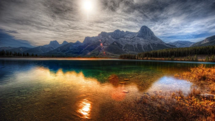 gray mountains calm body of water near mountain at daytime nature 2k