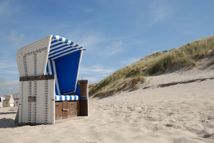 white wicker sofa on beach chair sylt clubs sea sky 2k