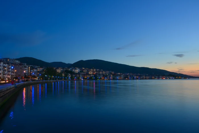 cityscape near body of water and mountain in background Landscape 2k 4k 5k