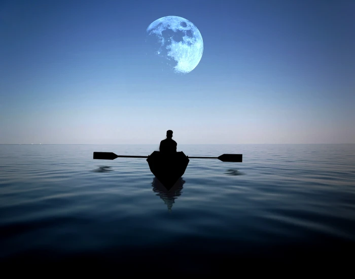 man riding on a boat alone in the sea with moon hovering above at night 2k 4k