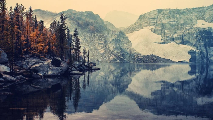 scenery of hill brown trees near body water and mountains 2k