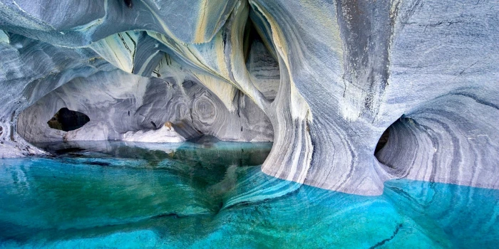 gray rock formation in water lake cave Chile erosion turquoise 2k