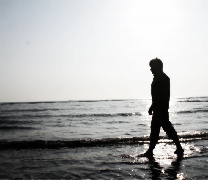 silhoutte of person near body water sad boy walking alone 2k