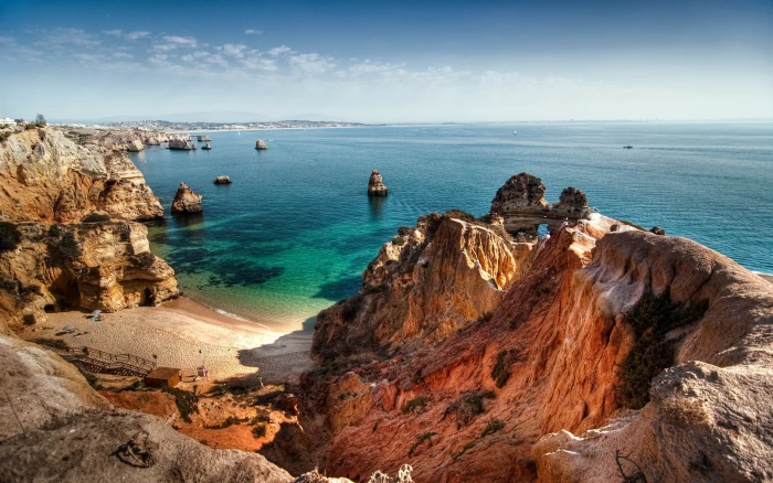 brown hill and body of water nature sea rock stones beach 2k