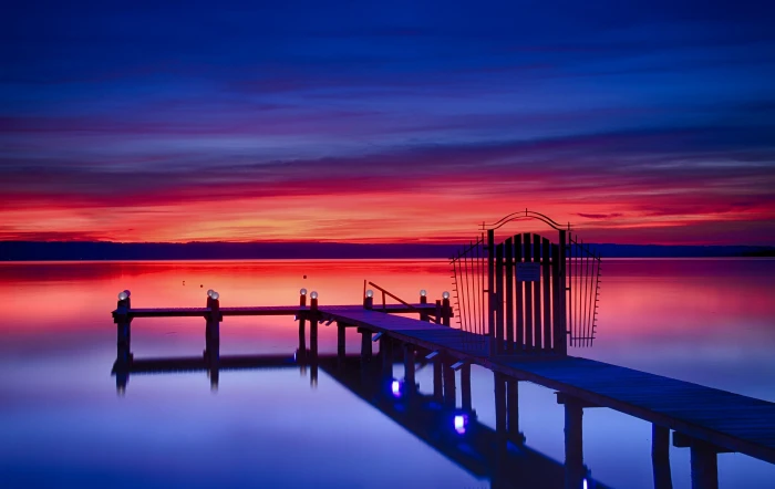 photography of brown wooden bridge reflecting over calm water 2k 4k