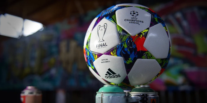 white and multicolored adidas soccer ball champions league 2k 4k