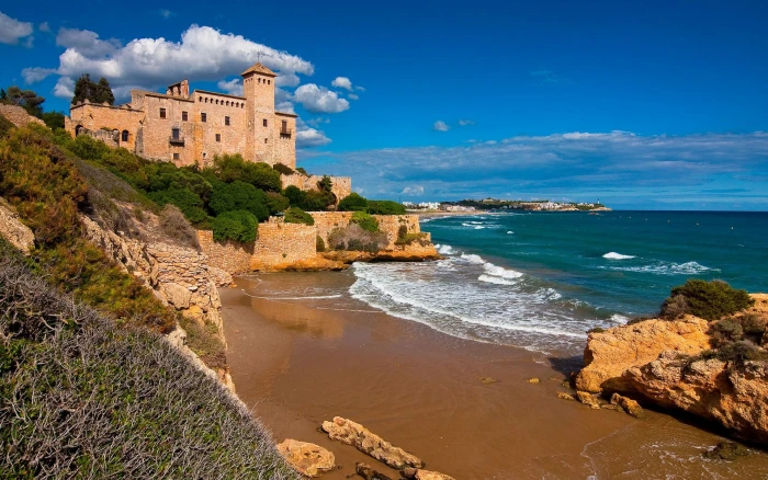 white and brown concrete house beach sky clouds Spain coast 2k