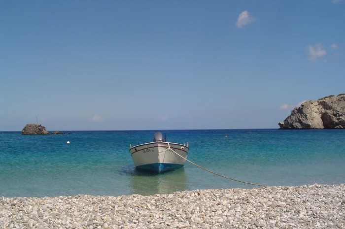 landscape photography of white boat in seashore greece karpathos 2k