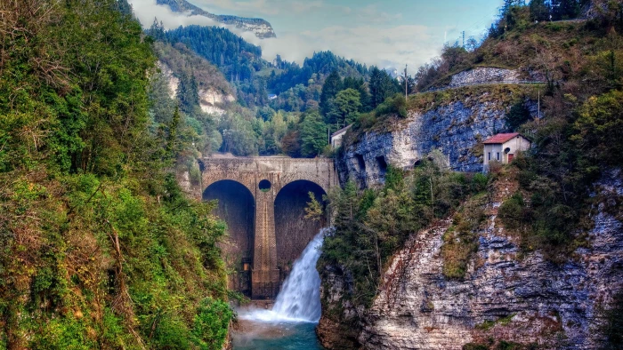 bridge with falls surrounded by trees architecture nature landscape 2k