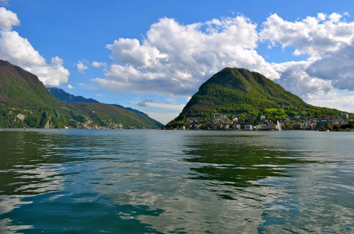 clouds houses lake lugano mountains nature scenery switzerland 2k
