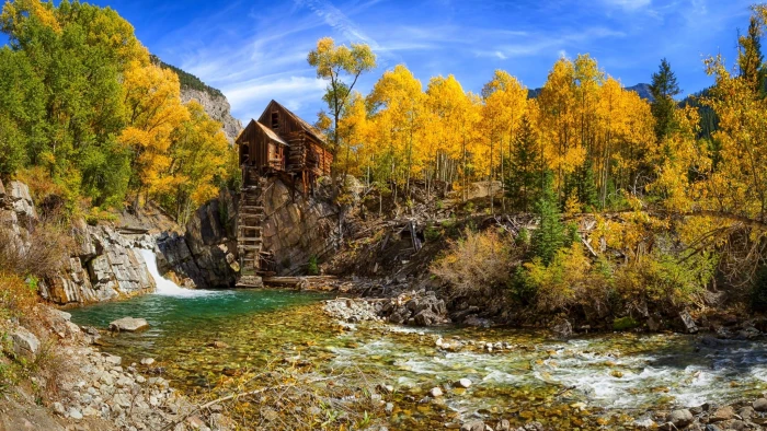 house on cliff near river painting fall nature forest Colorado 2k