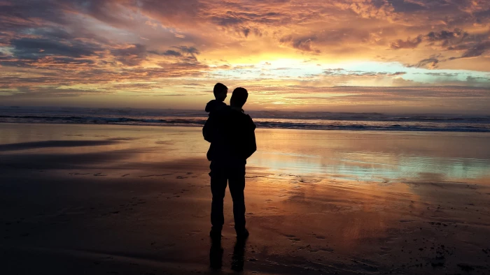 silhouette of man carrying baby beside the seashore father son 2k 4k