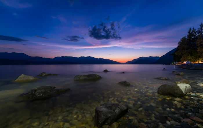 timelapse photography of body water near mountain during golden hour 2k 4k 5k