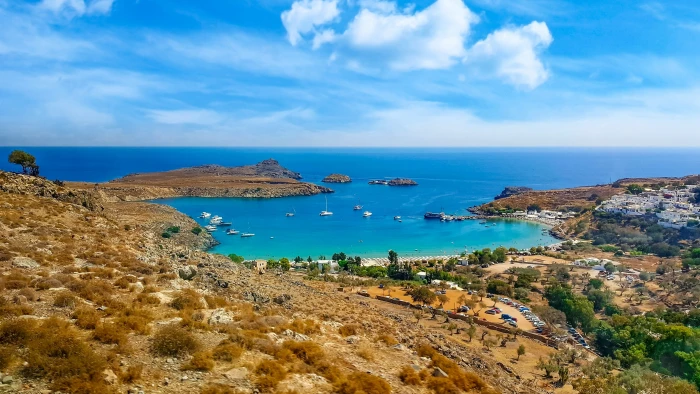 body of water besides brown island at daytime Greece Greek 2k