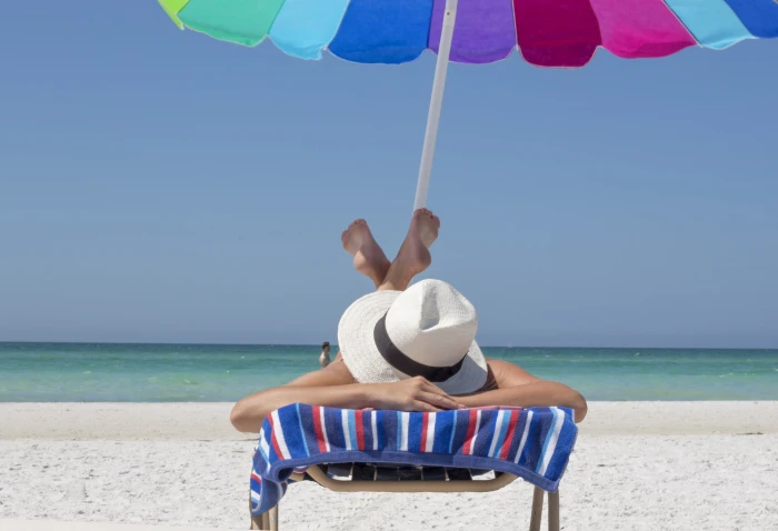 person lying down on beach chair vacation relax travel sun 2k 4k 5k