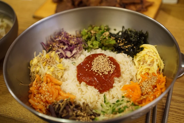 sliced of garlic carrots onions and cooked rice with ketchup on gray bowl 2k 4k