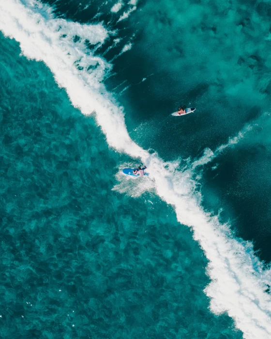 aerial view photo of two people surfing in body water photography person during daytime 2k