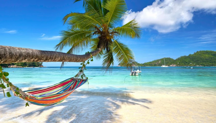 red blue yellow and green pinstriped hammock sand sea beach 2k
