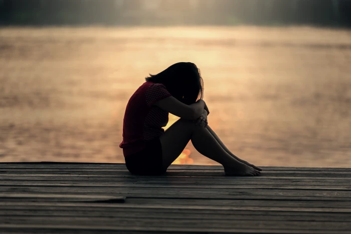 woman sitting in pavement near body of water back background 2k 4k 5k