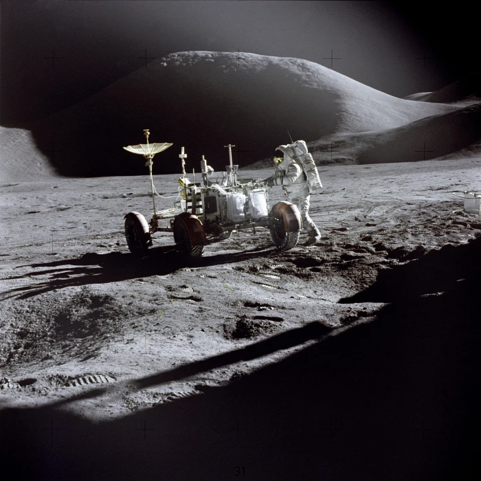 astronaut holding electronic machine with wheels on outer space 2k