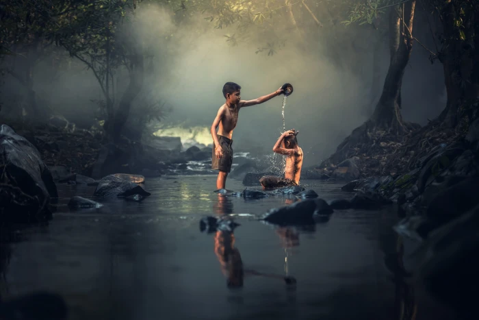 boy pouring water on person while the river asia boys creek 2k 4k 5k