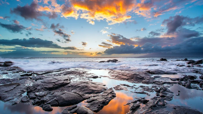 brown rocks under blue and orange sky water sea sunset coast 2k 4k