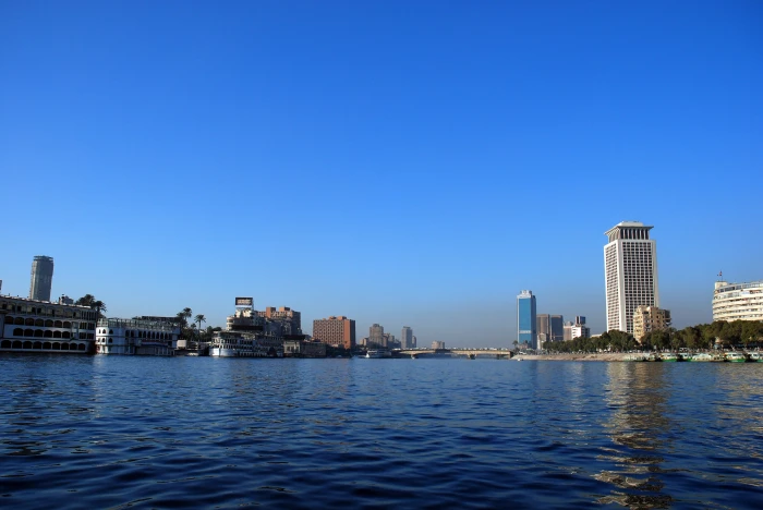 photography of body water near concrete buildings at daytime 2k 4k