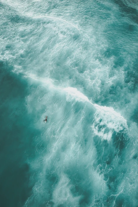 birds eye view photo of a person on body water surfing aerial photography 2k