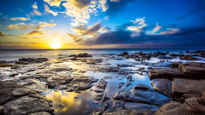 brown rock on shore photography rocks beach sunset sky sea 2k 4k
