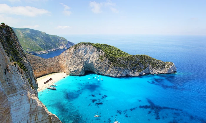 blue body of water near mountain during day time zakynthos greece 2k 4k 5k