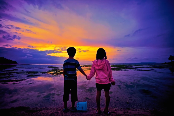 boy and girl holding each others hand while standing during sunset 2k 4k 5k